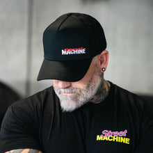 Man wearing Street Machine mast head black cap and black t-shirt with Street Machine Tacho tee