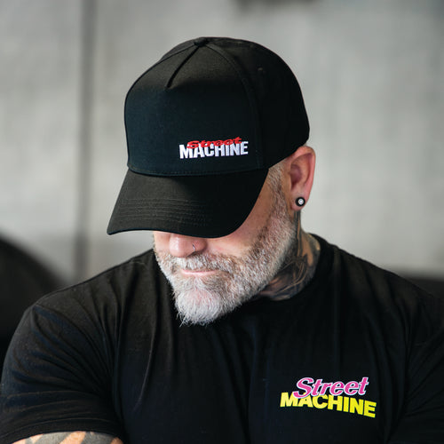 Man wearing Street Machine mast head black cap and black t-shirt with Street Machine Tacho tee